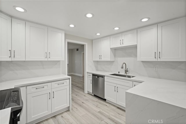 19029 Nordhoff St Unit 103, Northridge, CA 91324 - kitchen with stainless steel dishwasher, a sink, white cabinetry, light wood-type flooring, and recessed lighting