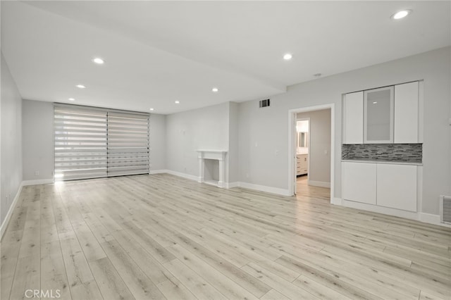 19029 Nordhoff St Unit 103, Northridge, CA 91324 - unfurnished living room with light wood finished floors, recessed lighting, and baseboards