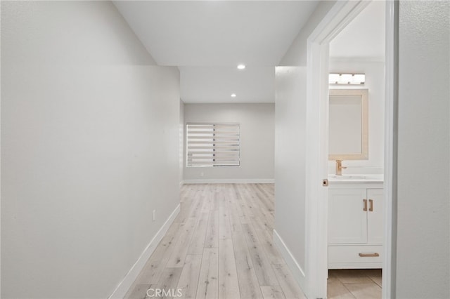 19029 Nordhoff St Unit 103, Northridge, CA 91324 - corridor featuring a sink, baseboards, recessed lighting, and light wood finished floors