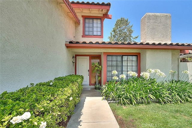 6237 Birdie Dr, La Verne, CA 91750 - view of exterior entry featuring a tiled roof and stucco siding