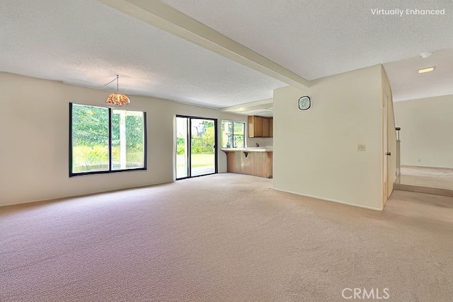 6237 Birdie Dr, La Verne, CA 91750 - unfurnished living room with light colored carpet, a textured ceiling, and beam ceiling