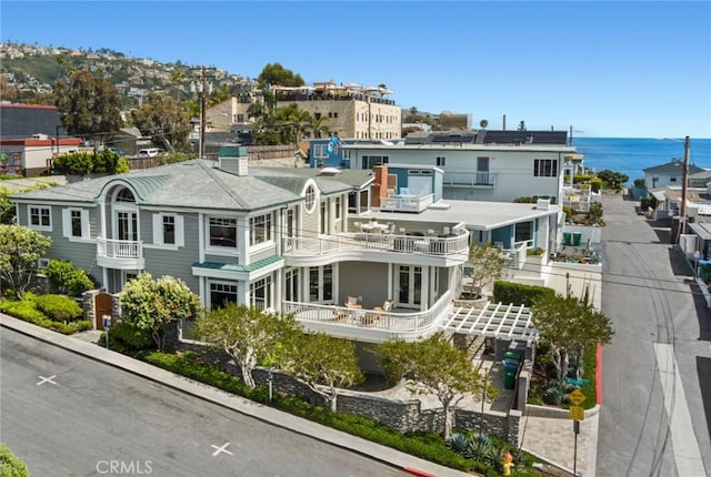 111 Brooks, Laguna Beach, CA 92651 - back of house featuring a water view, a balcony, and a chimney