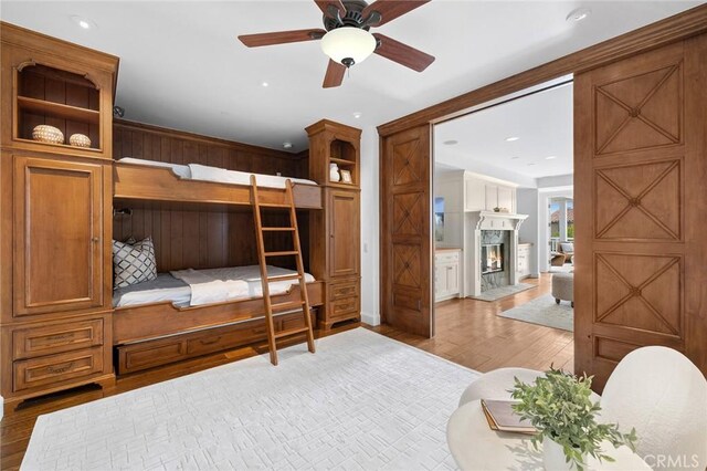 111 Brooks, Laguna Beach, CA 92651 - bedroom featuring wood finished floors, a premium fireplace, recessed lighting, and wooden walls