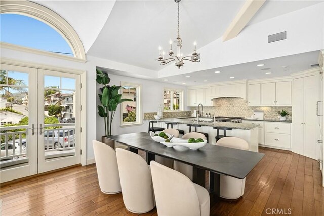 111 Brooks, Laguna Beach, CA 92651 - dining room featuring vaulted ceiling, a chandelier, wood-type flooring, and recessed lighting