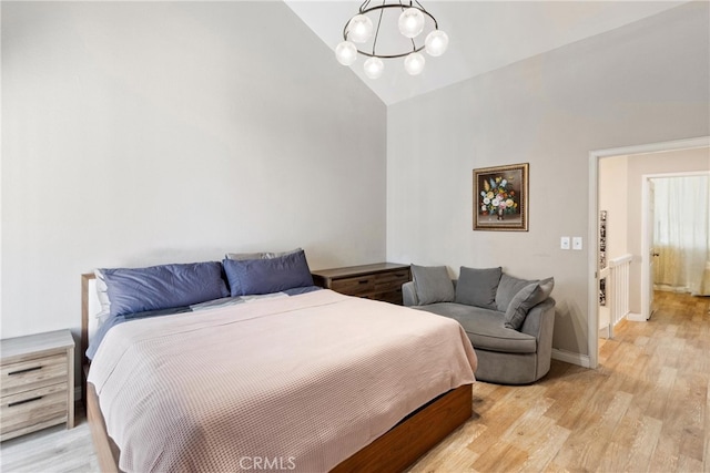 20645 Roscoe Blvd Unit G, Winnetka, CA 91306 - bedroom featuring a chandelier, high vaulted ceiling, light wood finished floors, and baseboards