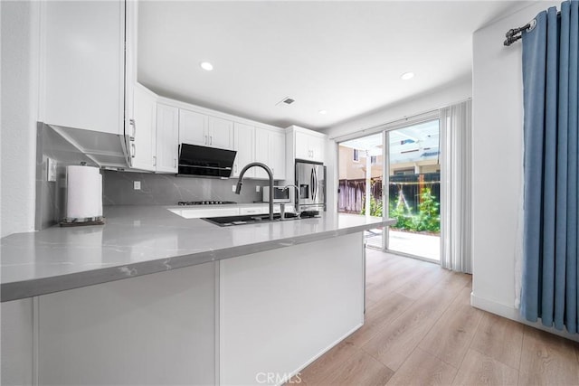 7358 Freedom Pl, Rancho Cucamonga, CA 91730 - kitchen featuring stainless steel refrigerator with ice dispenser, a sink, backsplash, white cabinets, and recessed lighting