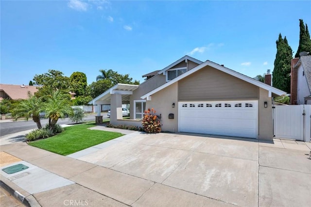 14652 Danborough Rd, Tustin, CA 92780 - view of front of property featuring stucco siding, a garage, driveway, and a gate