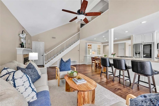 14652 Danborough Rd, Tustin, CA 92780 - living room featuring stairway, wood finished floors, high vaulted ceiling, a ceiling fan, and recessed lighting