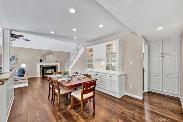 14652 Danborough Rd, Tustin, CA 92780 - dining space featuring a glass covered fireplace, dark wood-style flooring, ceiling fan, and recessed lighting