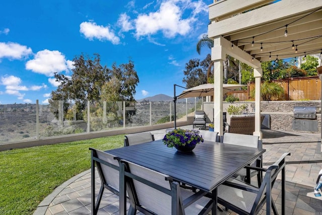 9552 Babauta Rd, San Diego, CA 92129 - fenced backyard with a patio area, a mountain view, exterior kitchen, and outdoor dining area