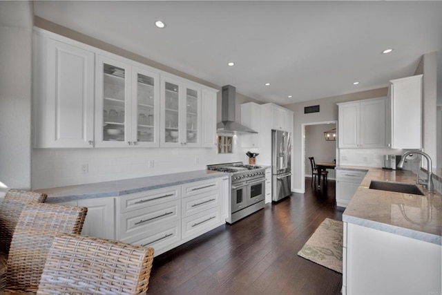 9552 Babauta Rd, San Diego, CA 92129 - kitchen with high quality appliances, wall chimney exhaust hood, white cabinetry, light stone counters, and tasteful backsplash