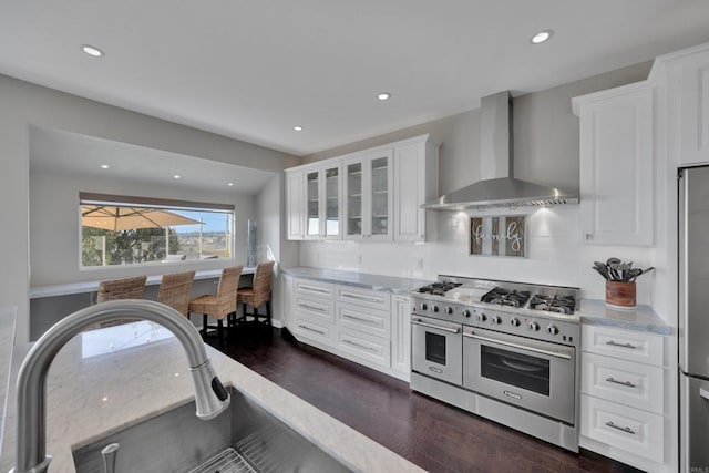 9552 Babauta Rd, San Diego, CA 92129 - kitchen with appliances with stainless steel finishes, wall chimney range hood, dark wood-style flooring, white cabinets, and glass insert cabinets
