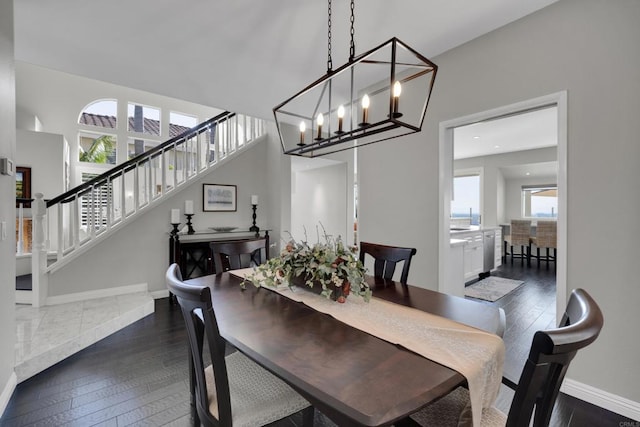 9552 Babauta Rd, San Diego, CA 92129 - dining room with dark wood finished floors, stairs, and a chandelier