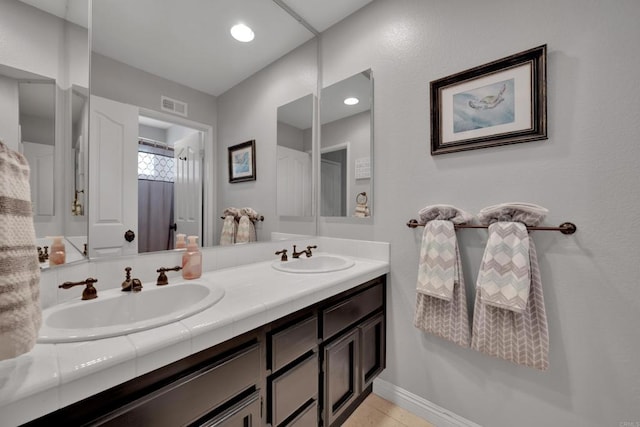 9552 Babauta Rd, San Diego, CA 92129 - bathroom with double vanity and tile patterned flooring