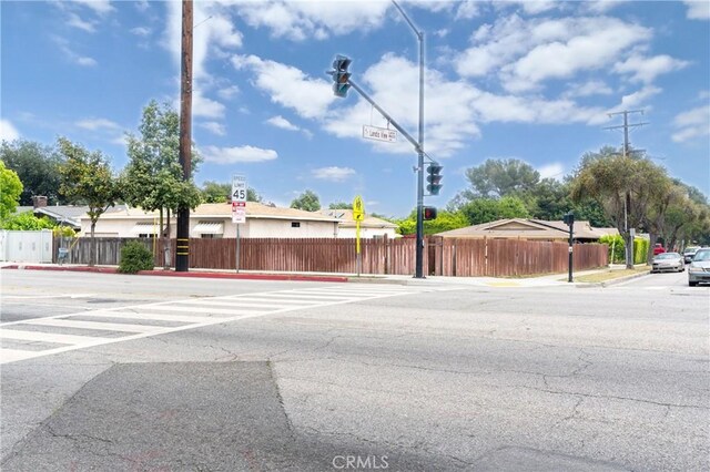 1026 Walnut Grove Ave, Rosemead, CA 91770 - view of asphalt road with traffic signs, sidewalks, curbs, traffic lights, and street lighting