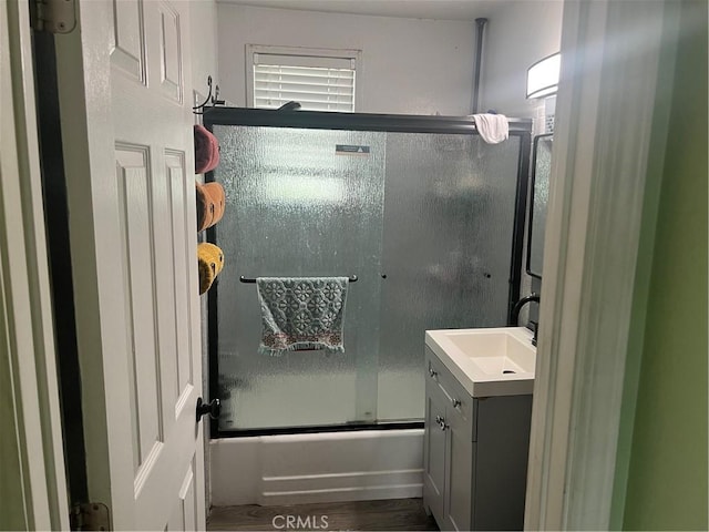 8943 Delano Dr, Riverside, CA 92503 - bathroom featuring bath / shower combo with glass door, vanity, and wood finished floors