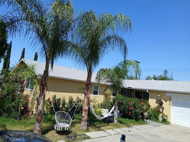 8943 Delano Dr, Riverside, CA 92503 - ranch-style house featuring stucco siding, an attached garage, and concrete driveway