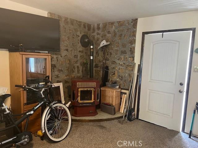 13238 Ebbtide, Clearlake Oaks, CA 95423 - carpeted living area featuring wallpapered walls and a wood stove