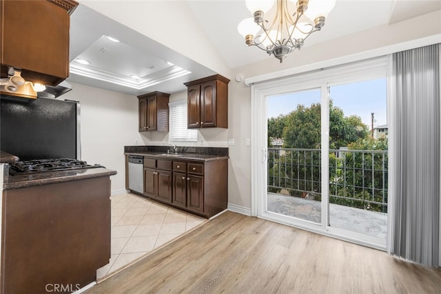 2925 E Spaulding St Unit 304, Long Beach, CA 90804 - kitchen with appliances with stainless steel finishes, dark countertops, a chandelier, dark brown cabinets, and light wood-style flooring