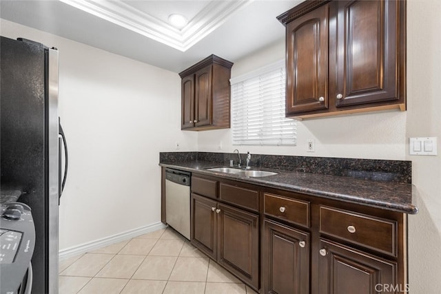 2925 E Spaulding St Unit 304, Long Beach, CA 90804 - kitchen with freestanding refrigerator, stainless steel dishwasher, dark brown cabinetry, dark stone counters, and light tile patterned floors