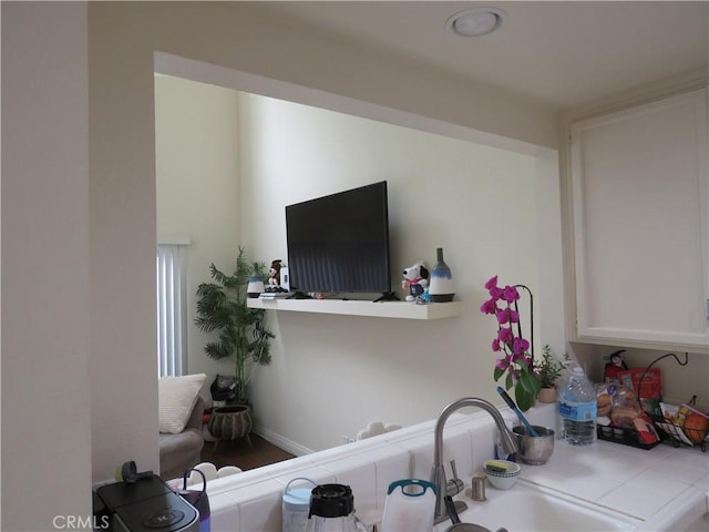 5744 E Creekside Ave Unit 10, Orange, CA 92869 - interior space with tile countertops, white cabinets, and a sink
