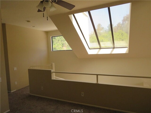 5744 E Creekside Ave Unit 10, Orange, CA 92869 - empty room with a skylight, a ceiling fan, and dark colored carpet