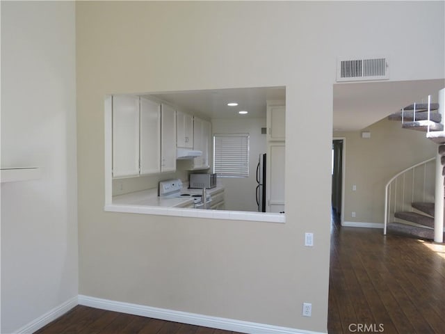 5744 E Creekside Ave Unit 10, Orange, CA 92869 - kitchen featuring freestanding refrigerator, white electric range, under cabinet range hood, dark wood finished floors, and baseboards