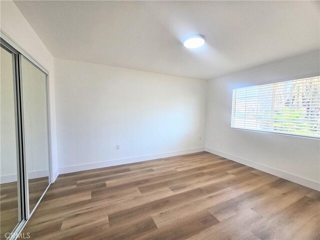 25687 Sandy Lodge Rd, Menifee, CA 92586 - unfurnished bedroom featuring light wood-type flooring, baseboards, and a closet