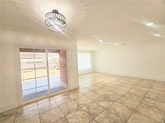25687 Sandy Lodge Rd, Menifee, CA 92586 - empty room featuring a chandelier, light tile patterned floors, and baseboards