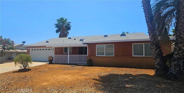 25687 Sandy Lodge Rd, Menifee, CA 92586 - ranch-style house with brick siding, a garage, and driveway