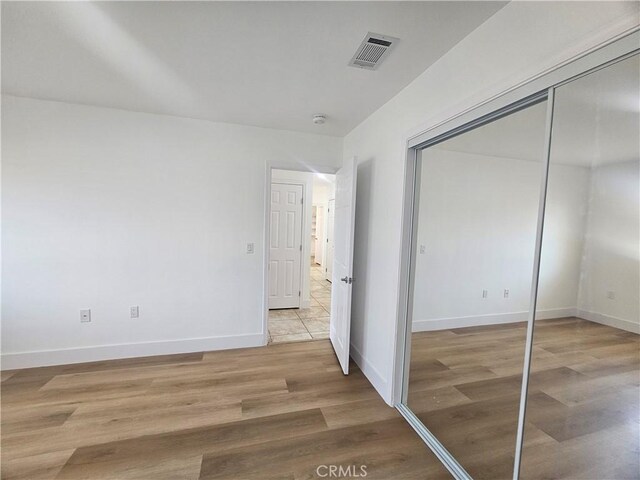 25687 Sandy Lodge Rd, Menifee, CA 92586 - unfurnished bedroom with light wood-style floors, a closet, and baseboards