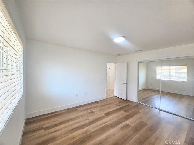 25687 Sandy Lodge Rd, Menifee, CA 92586 - unfurnished bedroom featuring light wood-style flooring, baseboards, and a closet