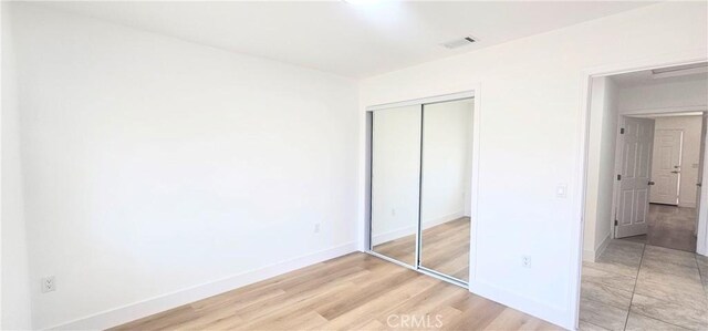 25687 Sandy Lodge Rd, Menifee, CA 92586 - unfurnished bedroom with a closet, light wood-type flooring, and baseboards