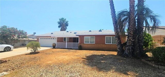 25687 Sandy Lodge Rd, Menifee, CA 92586 - ranch-style home with driveway, brick siding, and an attached garage