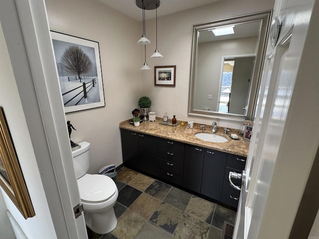 2552 Singing Vista Way, El Cajon, CA 92019 - bathroom with toilet, vanity, stone finish floors, and baseboards