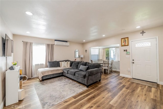 414 Iowa Ave, Riverside, CA 92507 - living room with an AC wall unit, recessed lighting, and light wood finished floors