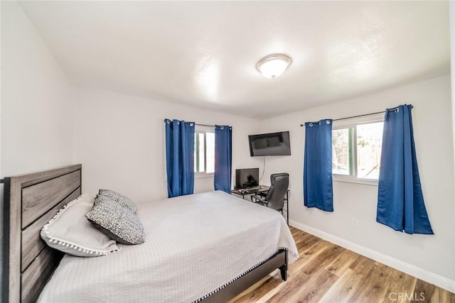 414 Iowa Ave, Riverside, CA 92507 - bedroom with multiple windows and wood finished floors