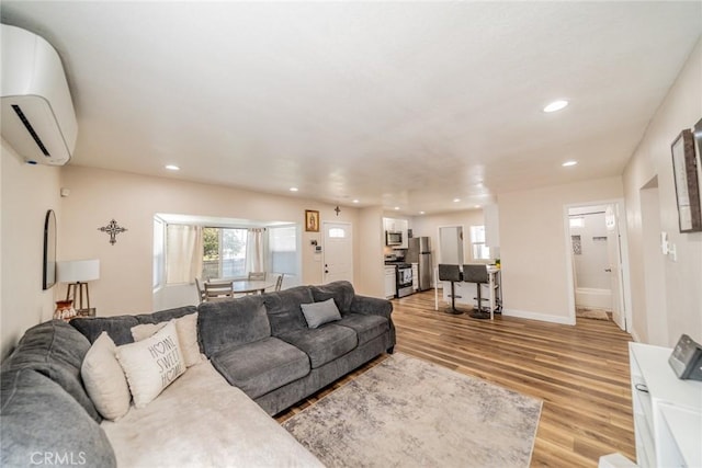 414 Iowa Ave, Riverside, CA 92507 - living area with a wall unit AC, light wood-type flooring, and recessed lighting