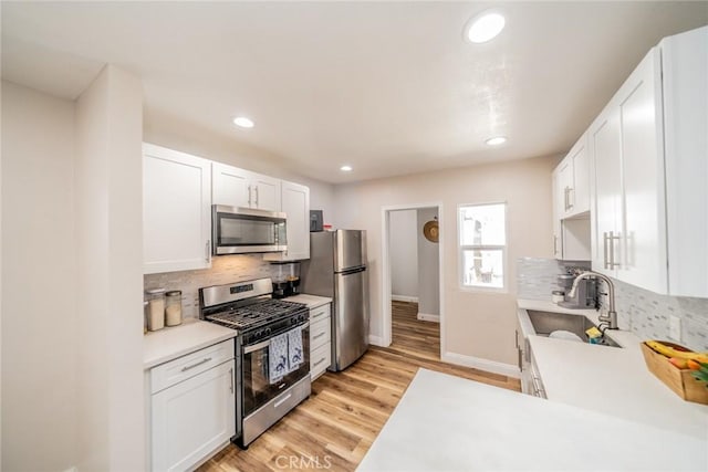 414 Iowa Ave, Riverside, CA 92507 - kitchen featuring stainless steel appliances, light countertops, tasteful backsplash, recessed lighting, and white cabinets