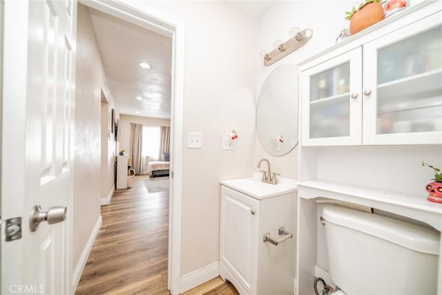 414 Iowa Ave, Riverside, CA 92507 - half bathroom featuring vanity, wood finished floors, and recessed lighting