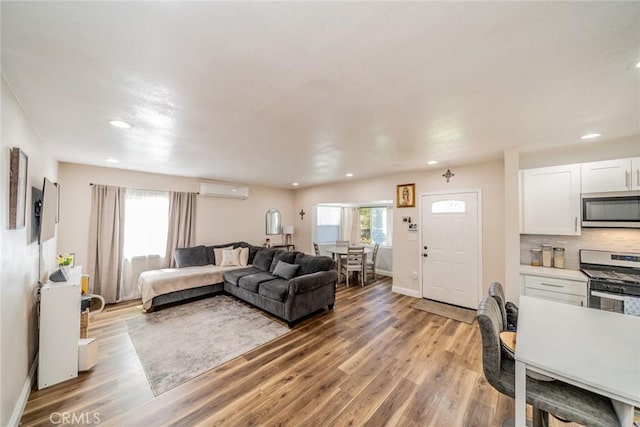 414 Iowa Ave, Riverside, CA 92507 - living room with a wall mounted air conditioner, recessed lighting, and light wood-style floors