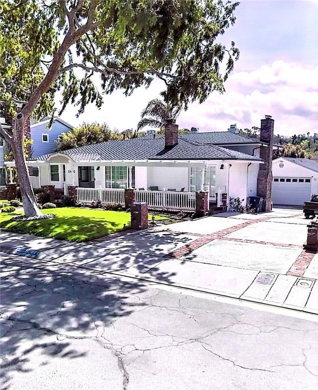 5426 Sharynne Ln, Torrance, CA 90505 - view of front of property with a chimney, a porch, driveway, a detached garage, and stucco siding