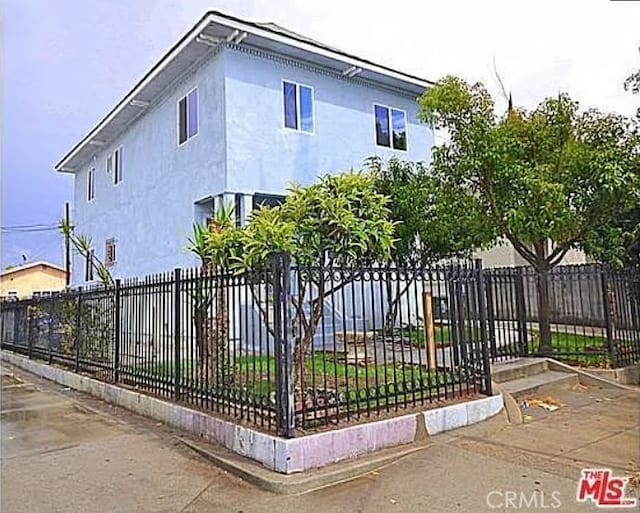 5102 Woodlawn Ave, Los Angeles, CA 90011 - view of front facade with stucco siding