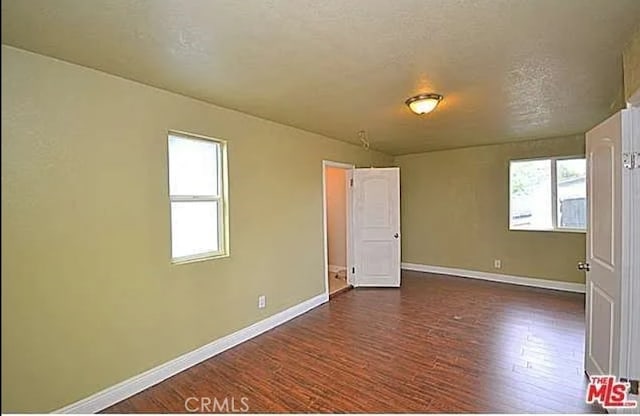 5102 Woodlawn Ave, Los Angeles, CA 90011 - unfurnished room featuring dark wood-type flooring