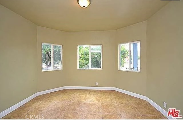5102 Woodlawn Ave, Los Angeles, CA 90011 - unfurnished room featuring plenty of natural light and tile patterned flooring