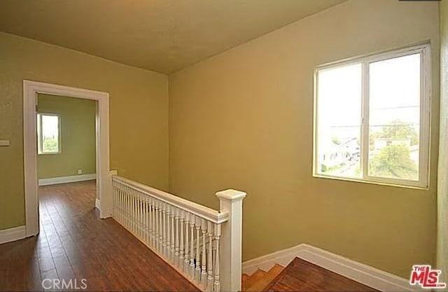 5102 Woodlawn Ave, Los Angeles, CA 90011 - hall with an upstairs landing, healthy amount of natural light, and wood finished floors
