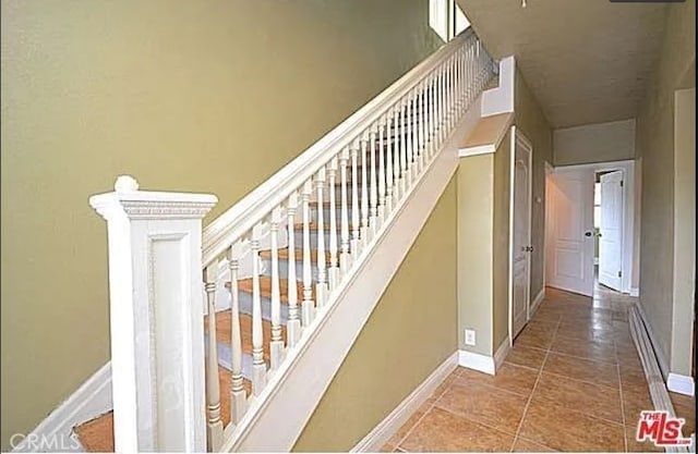5102 Woodlawn Ave, Los Angeles, CA 90011 - stairs featuring baseboards and tile patterned flooring