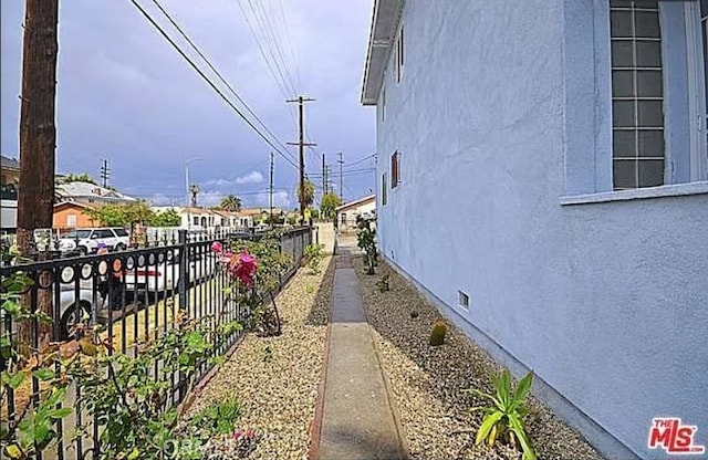 5102 Woodlawn Ave, Los Angeles, CA 90011 - view of side of home featuring stucco siding and crawl space