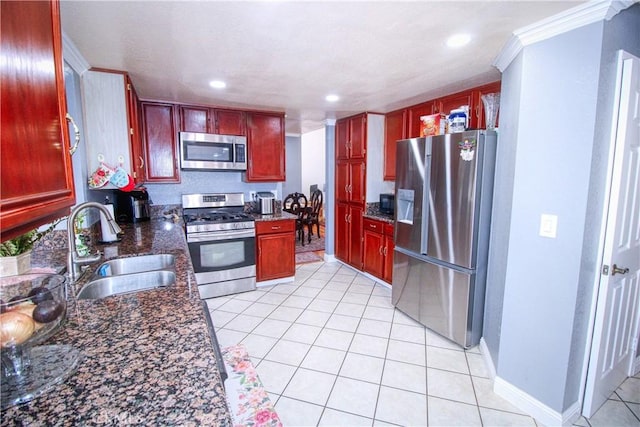 27126 Majello Ct, Temecula, CA 92591 - kitchen with appliances with stainless steel finishes, dark brown cabinets, light tile patterned flooring, recessed lighting, and dark stone countertops