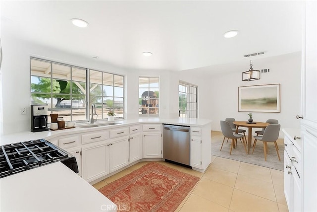 18346 Hackberry St, Hesperia, CA 92345 - kitchen with stainless steel dishwasher, a sink, light countertops, black range with gas stovetop, and light tile patterned flooring